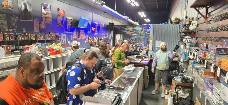 Customers browsing shelves and trading cards during a busy store event