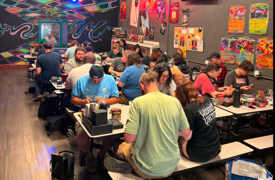 Players gathered at the tables for a busy game night at Dragon Door Collectibles